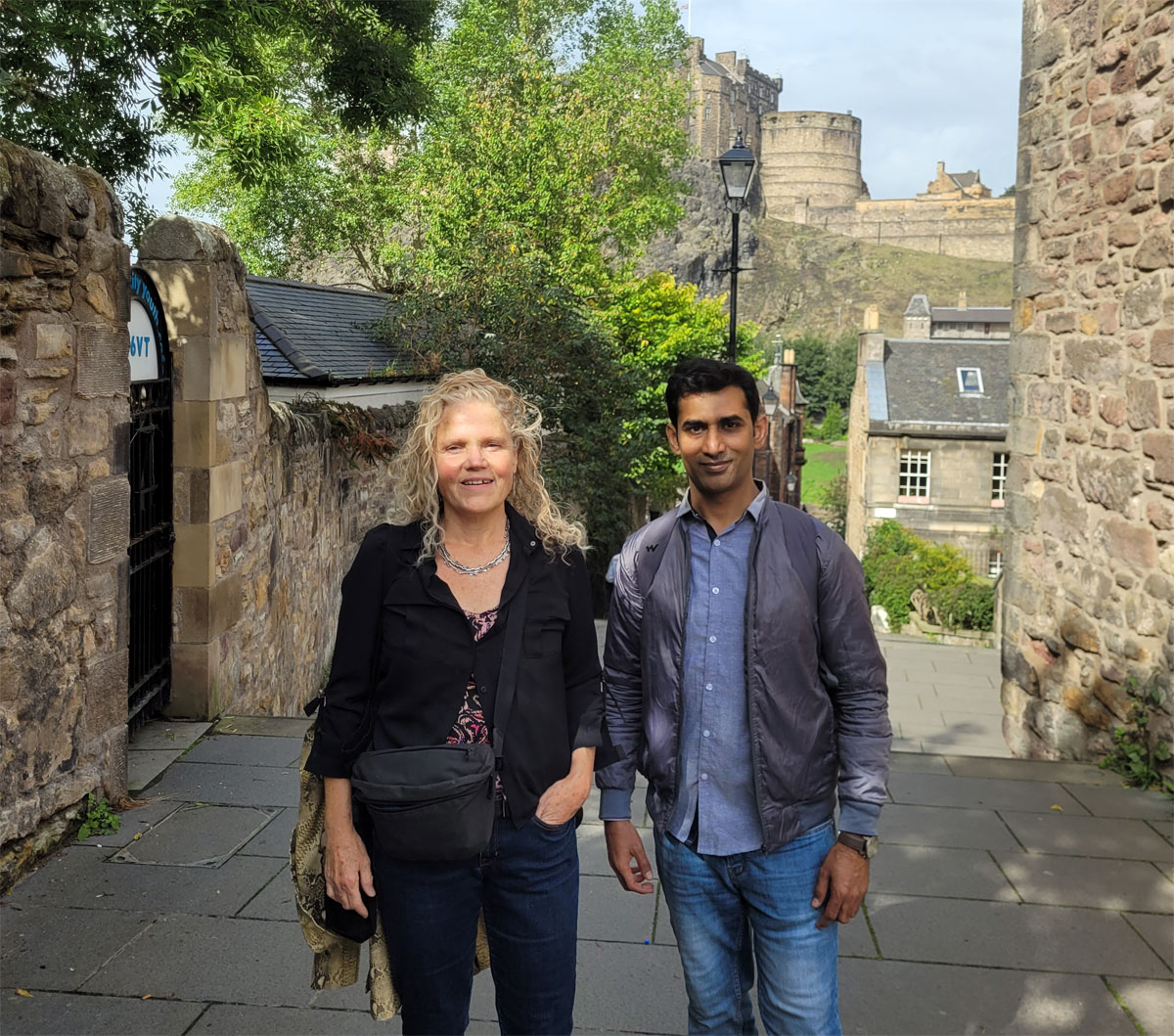 Michele and Farrukh at Grassmarket, Edinburgh castle in the background
