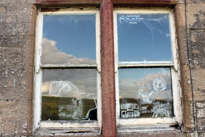 Close-up exterior detail of painted cottage windows