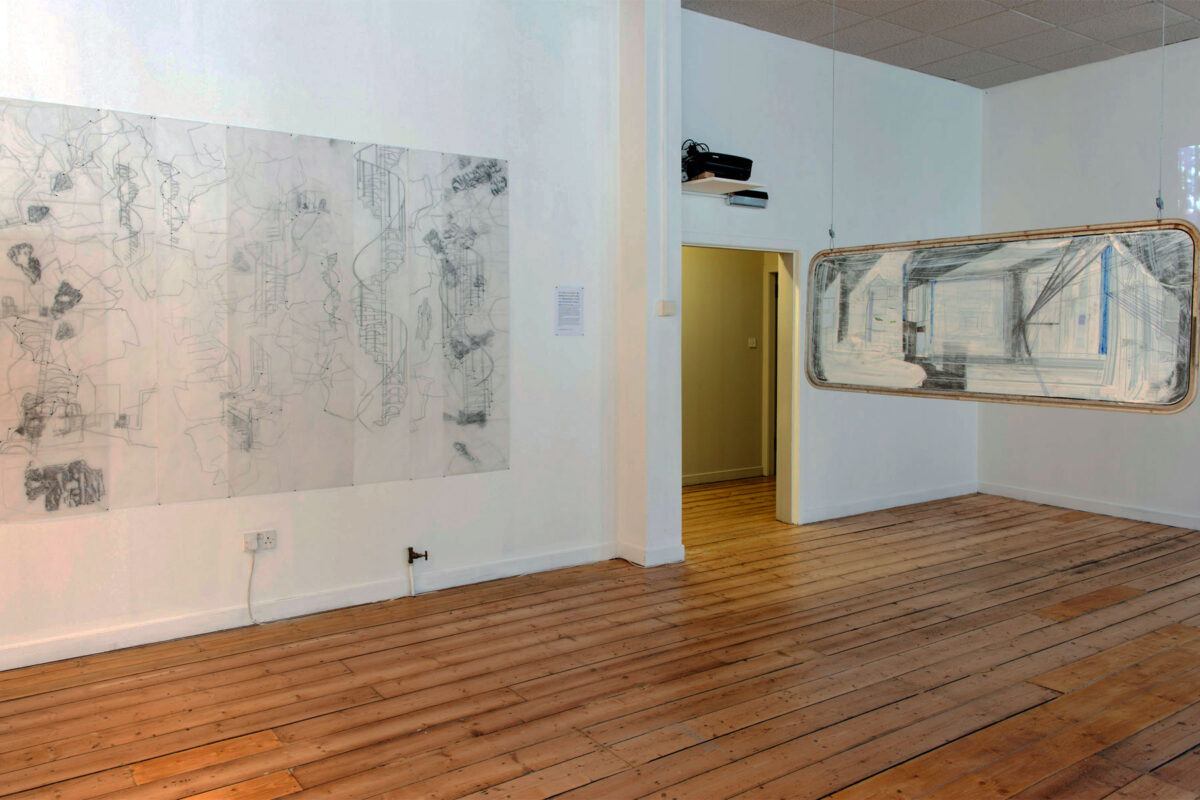 Installation view with tracing paper wall drawing and sgraffito caravan window drawing