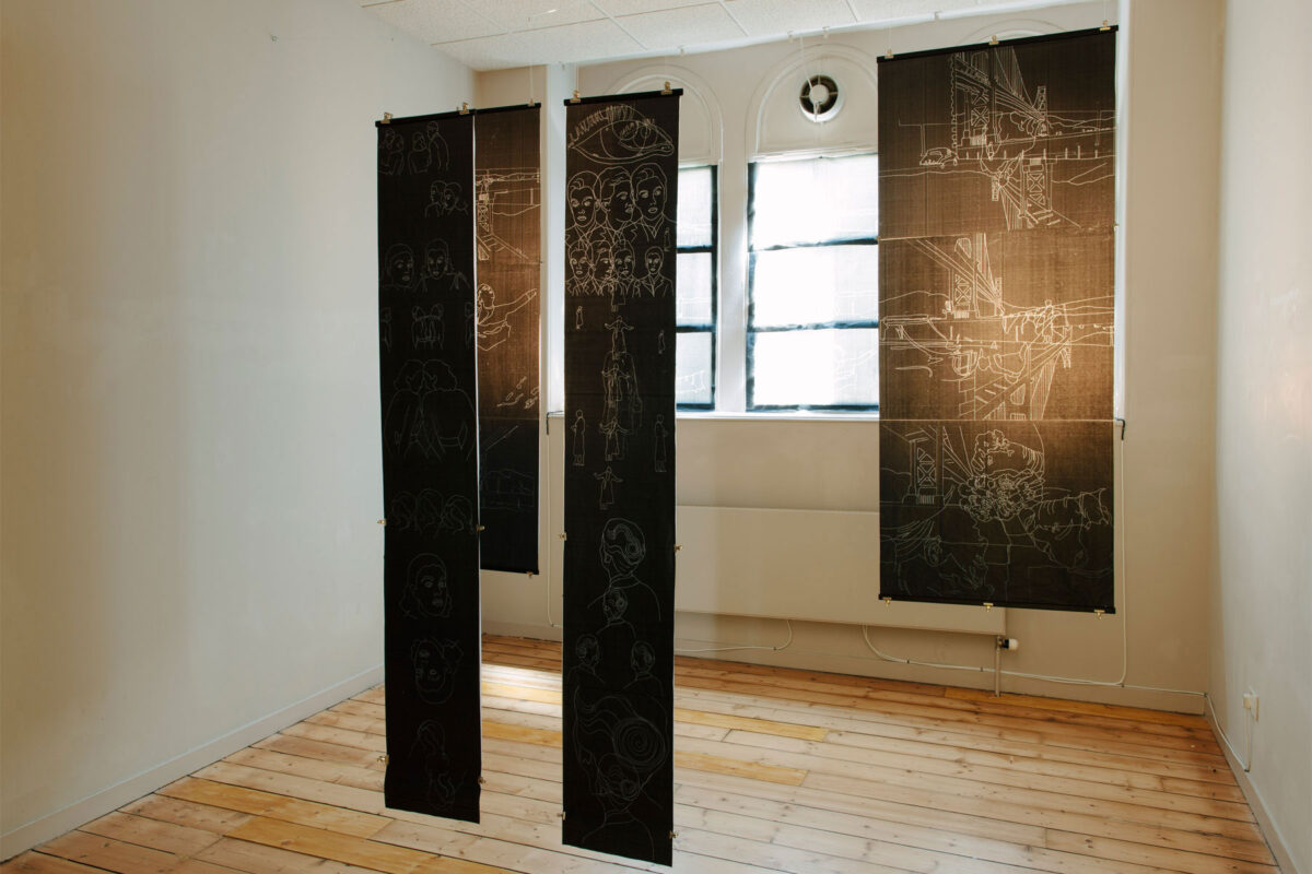 Wider installation view of Rescue with hanging carbon paper drawings and window drawings