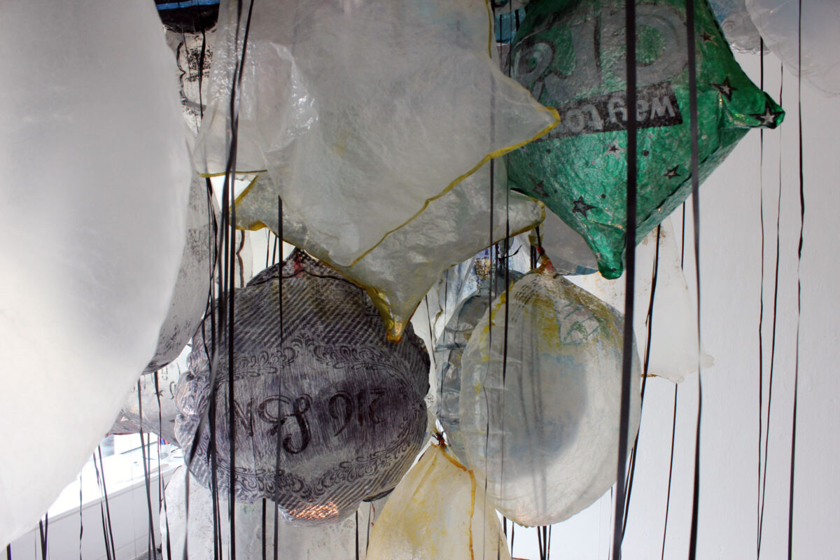 Close-up of green, silver and black balloons in GYRE