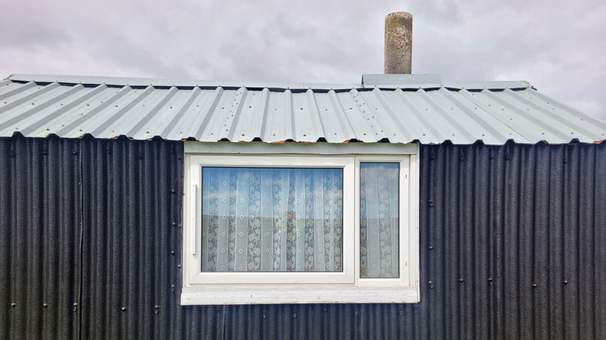Curtained hut window at Cuidhsiadar on the Isle of Lewis