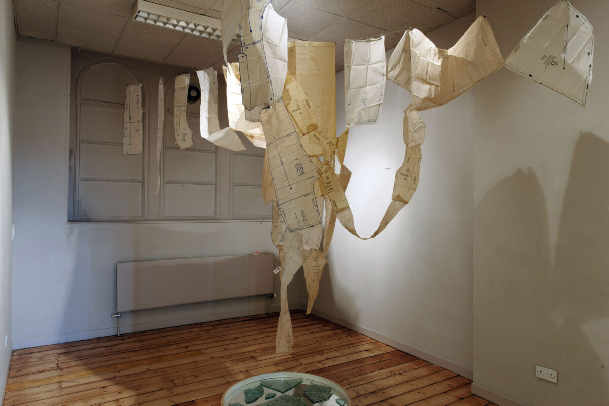Installation view of Clootie Well sculpture made from dressmaking patterns, playing cards and glass